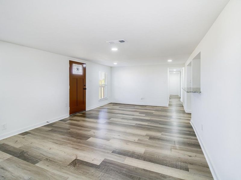 Empty room featuring recessed lighting and wood finished floors Empty room featuring recessed lighting and wood finished floors