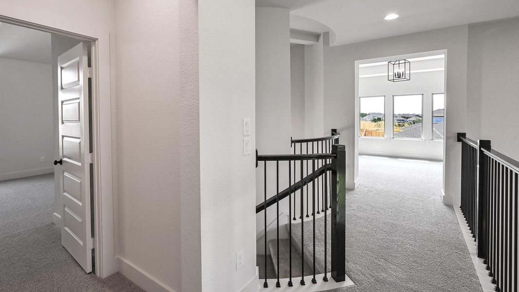 Hall with an upstairs landing, carpet flooring, baseboards, and recessed lighting