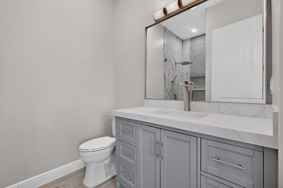Clean lines and stone counters highlight this updated modern bathroom.