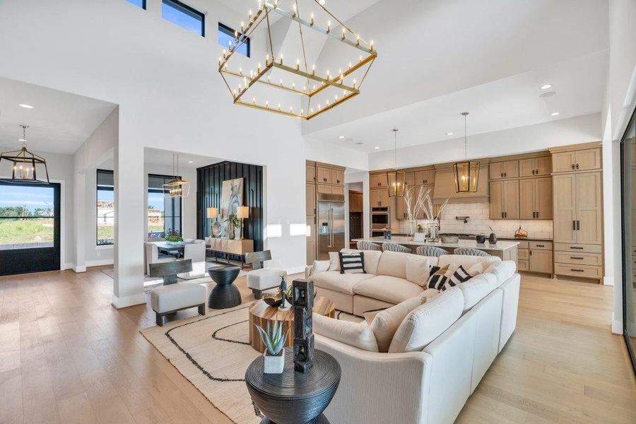 Living room with double height ceiling with glass sliding doors to back porch Living room with double height ceiling with glass sliding doors to back porch