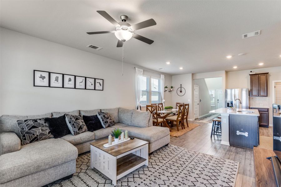 Living area with light wood-style flooring, recessed lighting, and ceiling fan