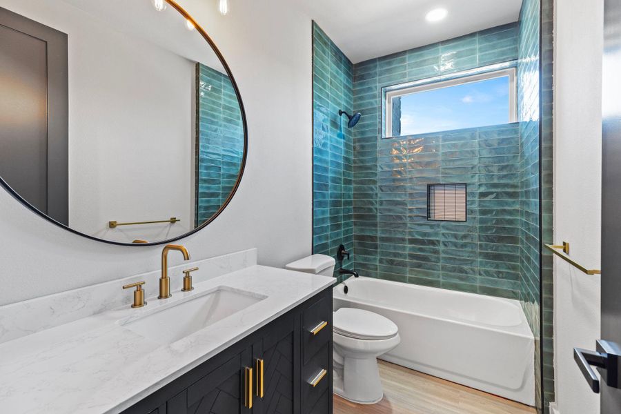 Full bathroom featuring vanity, shower / tub combination, toilet, and wood finished floors