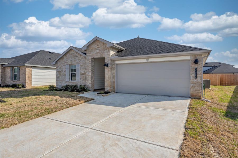 Front exterior of a new home in Tamarron, Fulshear, TX, highlighting curb appeal (Image 2). Front exterior of a new home in Tamarron, Fulshear, TX, highlighting curb appeal (Image 2).