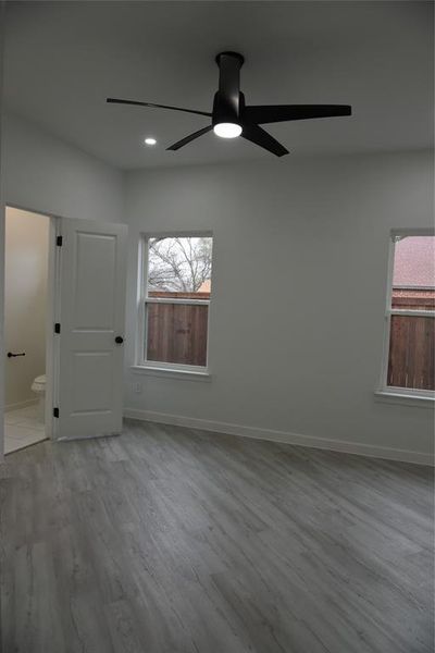 Unfurnished room with light hardwood / wood-style floors and ceiling fan