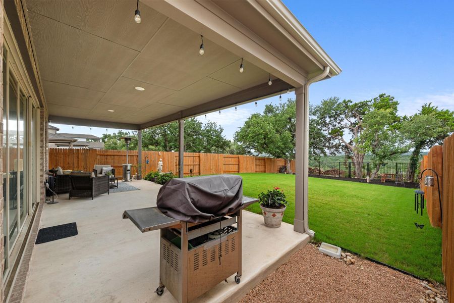 An inviting covered patio seamlessly extends outdoor living with ample space for entertaining and enjoying the lush backyard. An inviting covered patio seamlessly extends outdoor living with ample space for entertaining and enjoying the lush backyard.