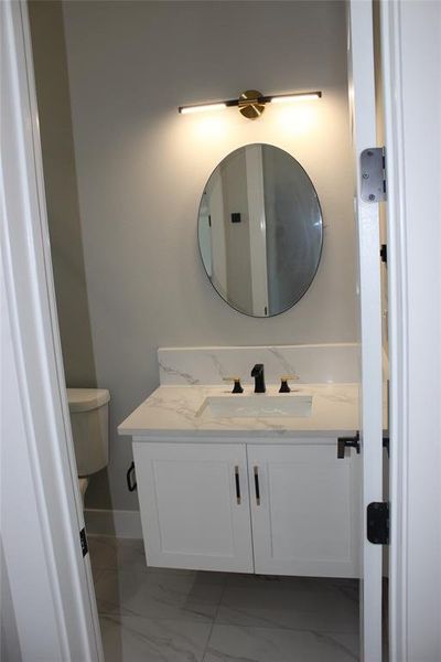 Bathroom featuring vanity and toilet