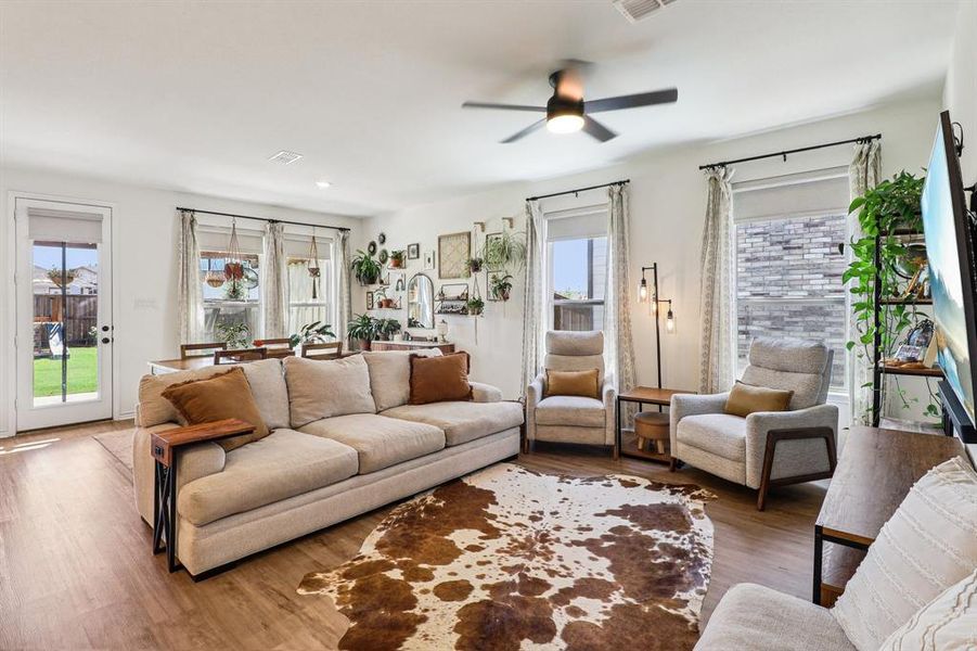 Living room featuring wood finished floors and ceiling fan Living room featuring wood finished floors and ceiling fan