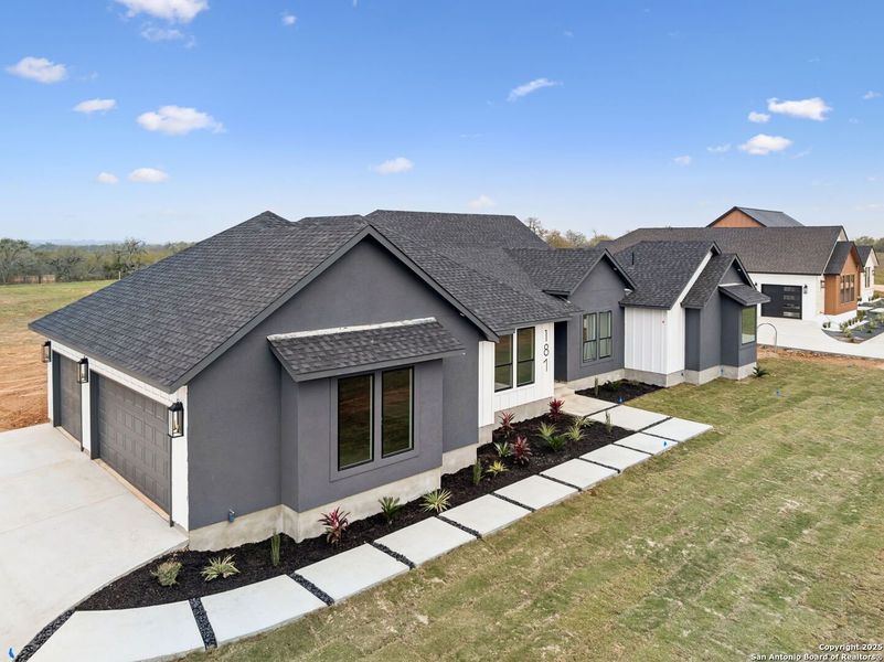 Front exterior of a new home in , Floresville, TX, highlighting curb appeal (Image 1). Front exterior of a new home in , Floresville, TX, highlighting curb appeal (Image 1).