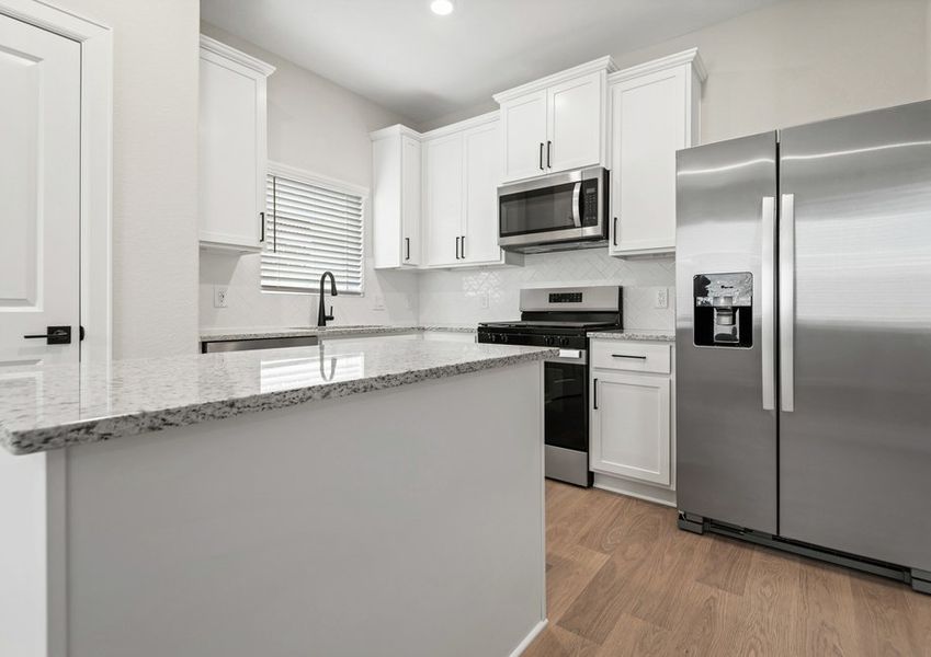 Kitchen with stainless steel appliances and white cabinets Kitchen with stainless steel appliances and white cabinets