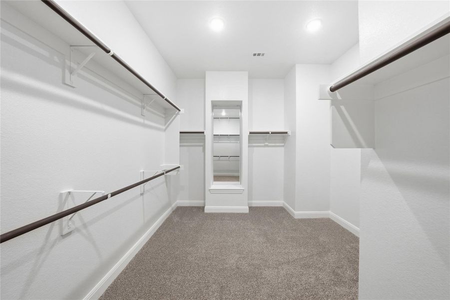 Walk in closet featuring light carpet