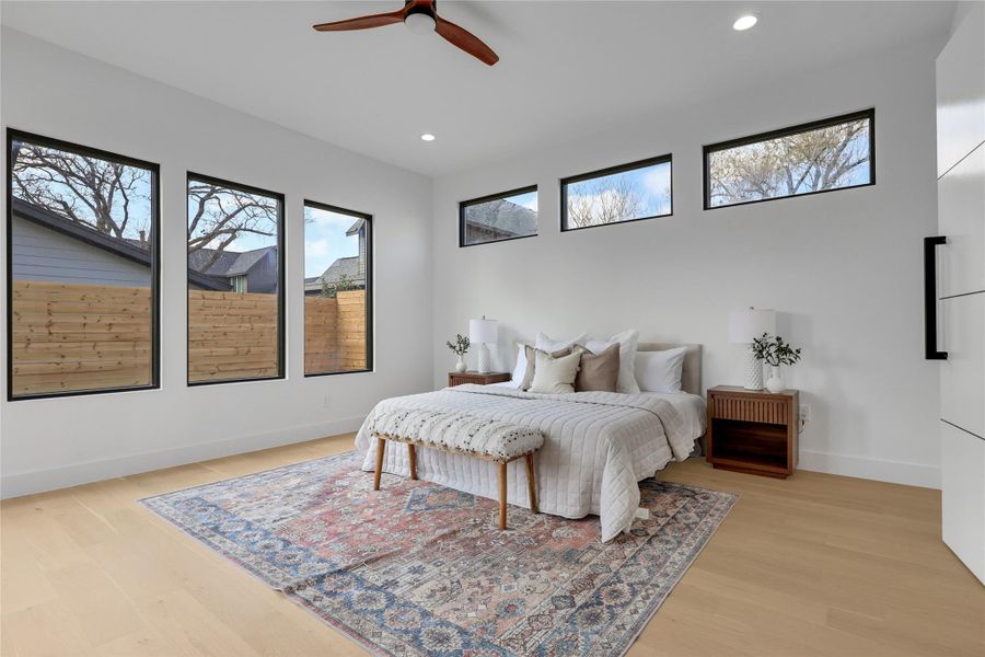 Bedroom with light wood-style flooring, a ceiling fan, and recessed lighting