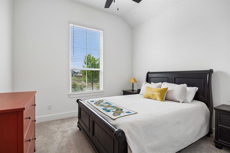 Spacious room with vaulted ceiling and light gray carpeting Spacious room with vaulted ceiling and light gray carpeting
