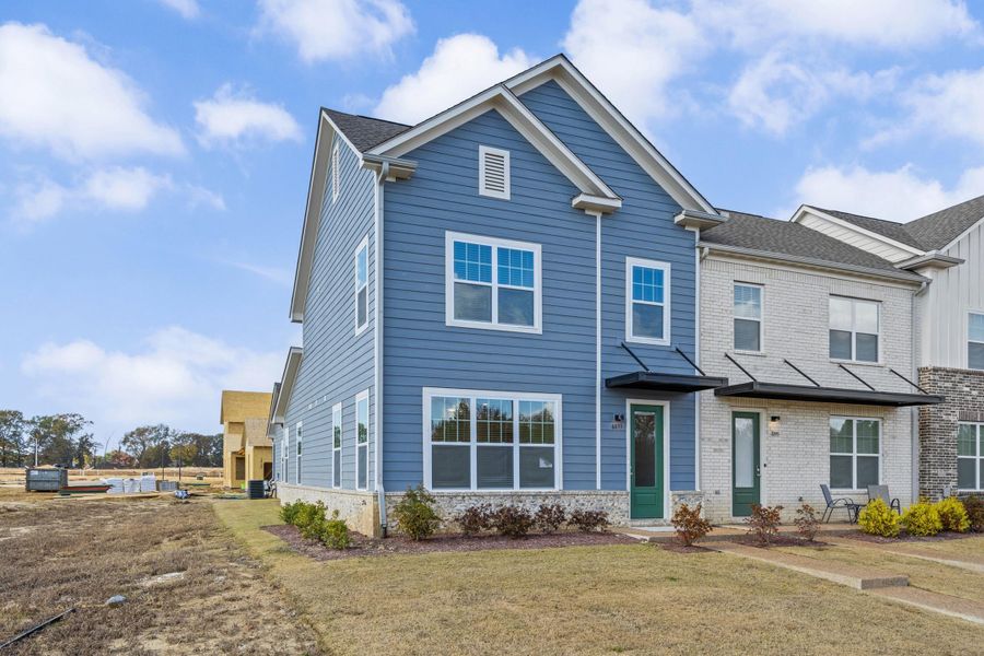View of front facade with a front lawn and brick siding