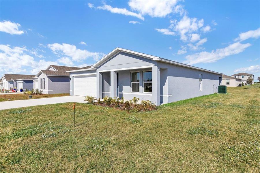 Front exterior of a new home in Stone Ridge, Sebring, FL, highlighting curb appeal (Image 6).
