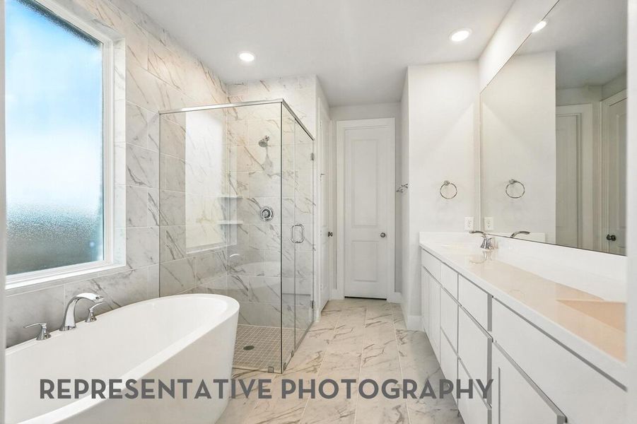 The primary bathroom features a luxurious freestanding tub and a spacious shower, creating a spa-like retreat.