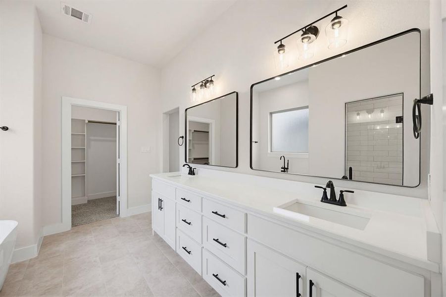 Double vanity with white cabinetry, matte black hardware, and integrated rectangular sinks