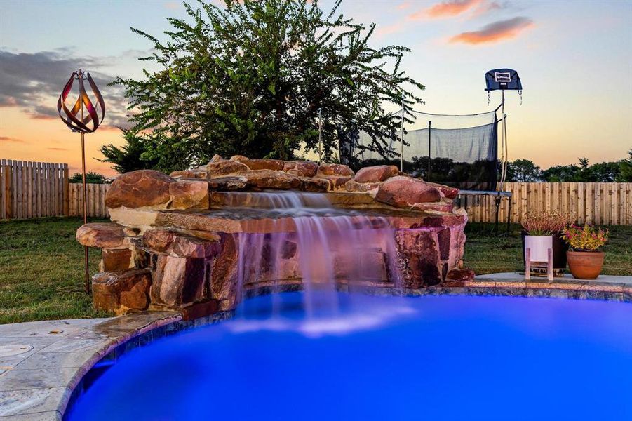 View of swimming pool featuring a patio area and a trampoline View of swimming pool featuring a patio area and a trampoline