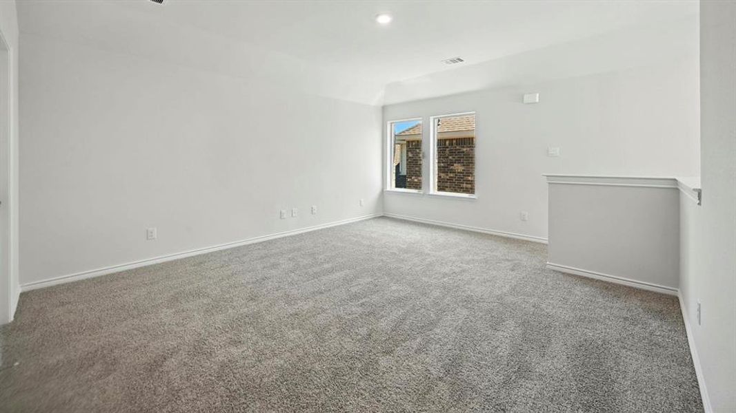 Empty room featuring carpet flooring and recessed lighting