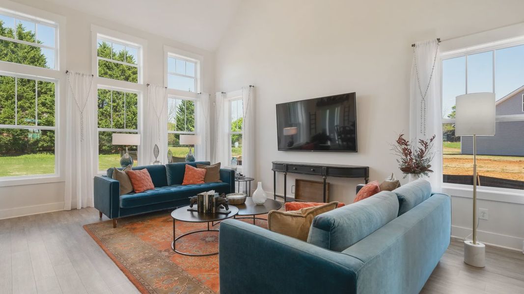 Tasteful family room with two-story volume, refined finishes, and exceptional natural light in Woodruff, SC