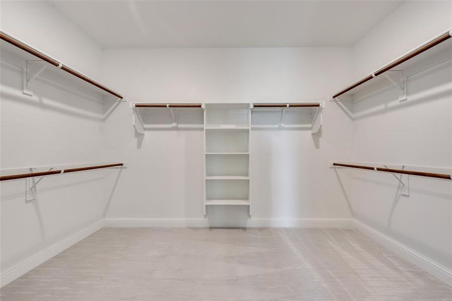 Walk in closet featuring light carpet