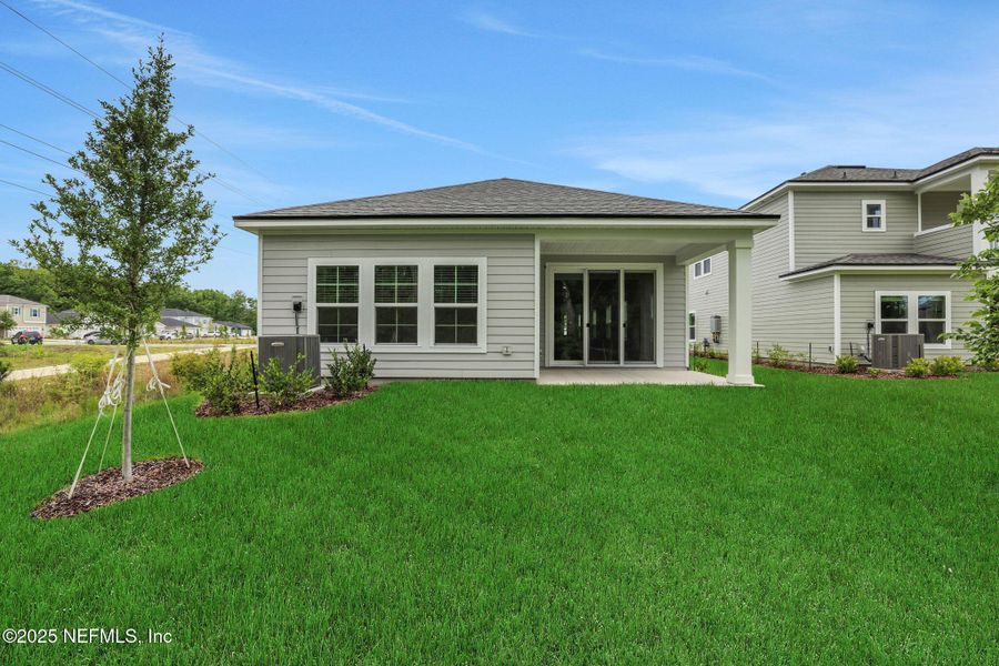 Front exterior of a new home in TrailMark, St. Augustine, FL, highlighting curb appeal (Image 18). Front exterior of a new home in TrailMark, St. Augustine, FL, highlighting curb appeal (Image 18).