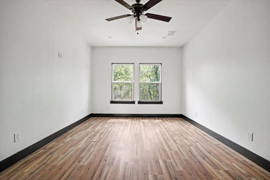 Unfurnished room featuring light wood-style flooring and a ceiling fan