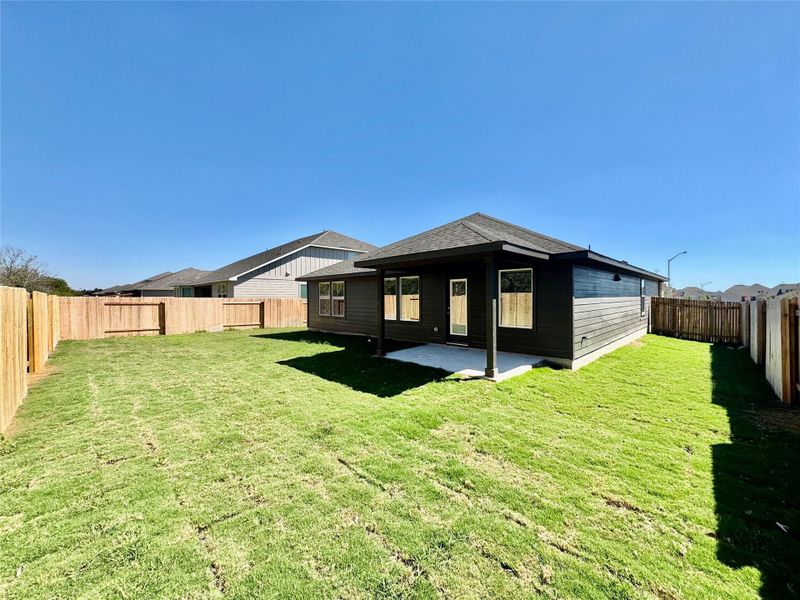 Rear view of house featuring a fenced backyard and a patio Rear view of house featuring a fenced backyard and a patio
