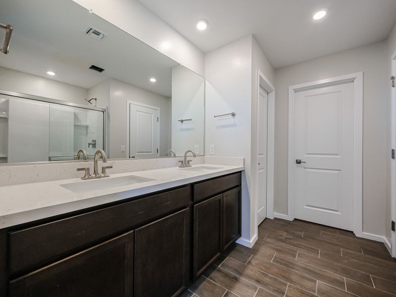 A bathroom with a large mirror.