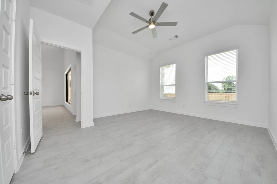 Come and unwind after a long day in this magnificent primary suite! This spacious room features warm paint, high ceilings and large windows with privacy blinds.