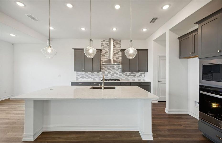 Bright kitchen with oversized island *real home pictured