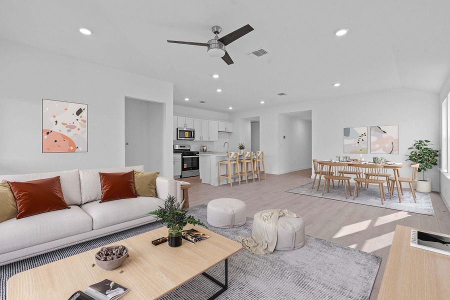 Living room with recessed lighting, a ceiling fan, light wood-style floors, and lofted ceiling