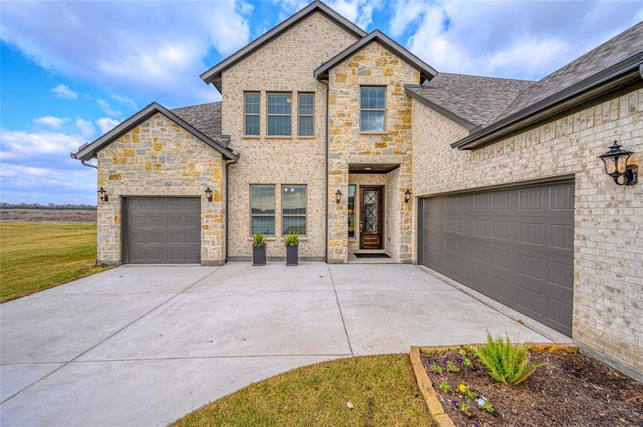Front exterior of a new home in Pioneer Estates, Blue Ridge, TX, highlighting curb appeal (Image 19).