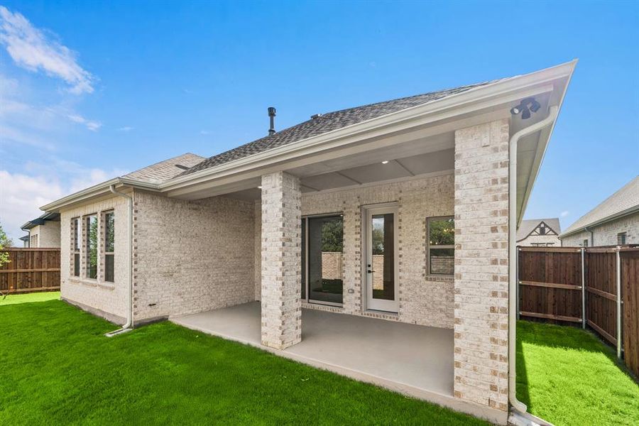 Back of property featuring a fenced backyard, brick siding, a patio, and a shingled roof Back of property featuring a fenced backyard, brick siding, a patio, and a shingled roof