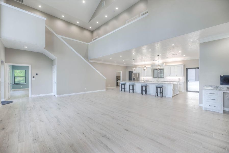 Living room area with a view of the huge, spacious kitchen with granite countertops and ample lighting (Building B) Living room area with a view of the huge, spacious kitchen with granite countertops and ample lighting (Building B)