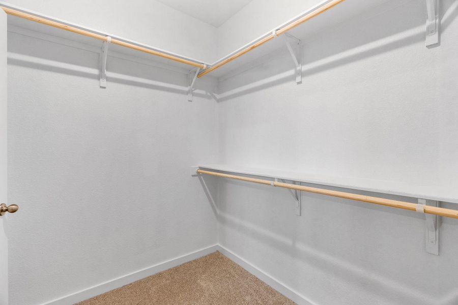 Walk in closet with light colored carpet Walk in closet with light colored carpet