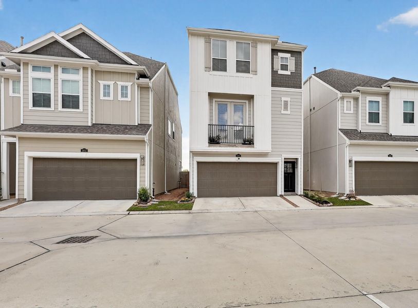 Contemporary three-story exterior with modern siding, clean architectural lines, and a covered front entry. Two-car garage and landscaped walkway offer welcoming curb appeal. Contemporary three-story exterior with modern siding, clean architectural lines, and a covered front entry. Two-car garage and landscaped walkway offer welcoming curb appeal.