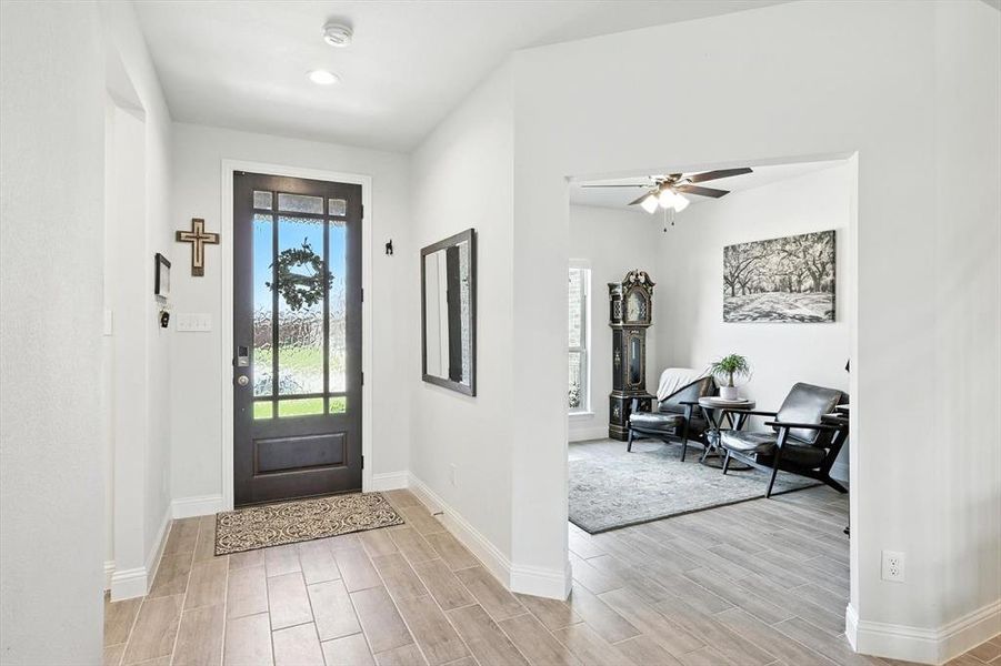 Entrance foyer featuring wood finish floors and ceiling fan