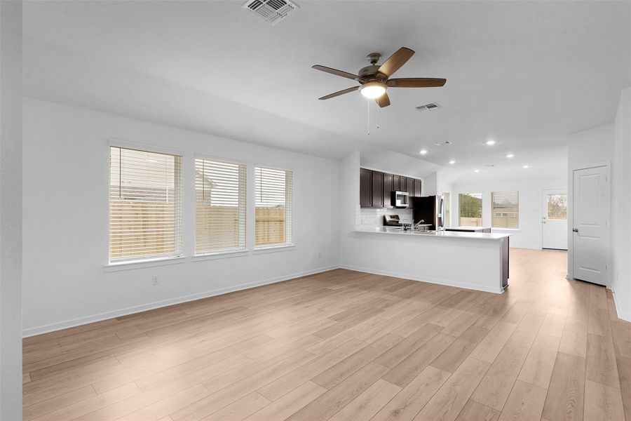 Unfurnished living room featuring light wood-style floors, ceiling fan, and recessed lighting