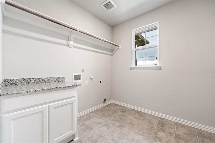 Laundry room with gas dryer hookup, hookup for an electric dryer, and washer hookup Laundry room with gas dryer hookup, hookup for an electric dryer, and washer hookup