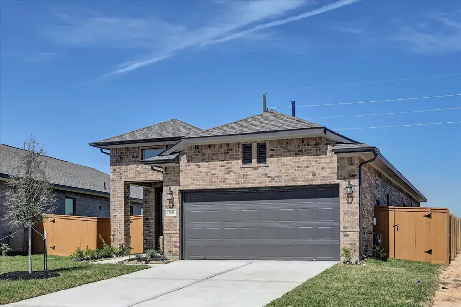 Front exterior of a new home in Sunterra 40, Katy, TX, highlighting curb appeal (Image 20).