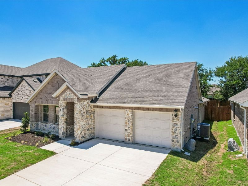 Front exterior of a new home in Stella Hills, Denton, TX, highlighting curb appeal (Image 24). Front exterior of a new home in Stella Hills, Denton, TX, highlighting curb appeal (Image 24).