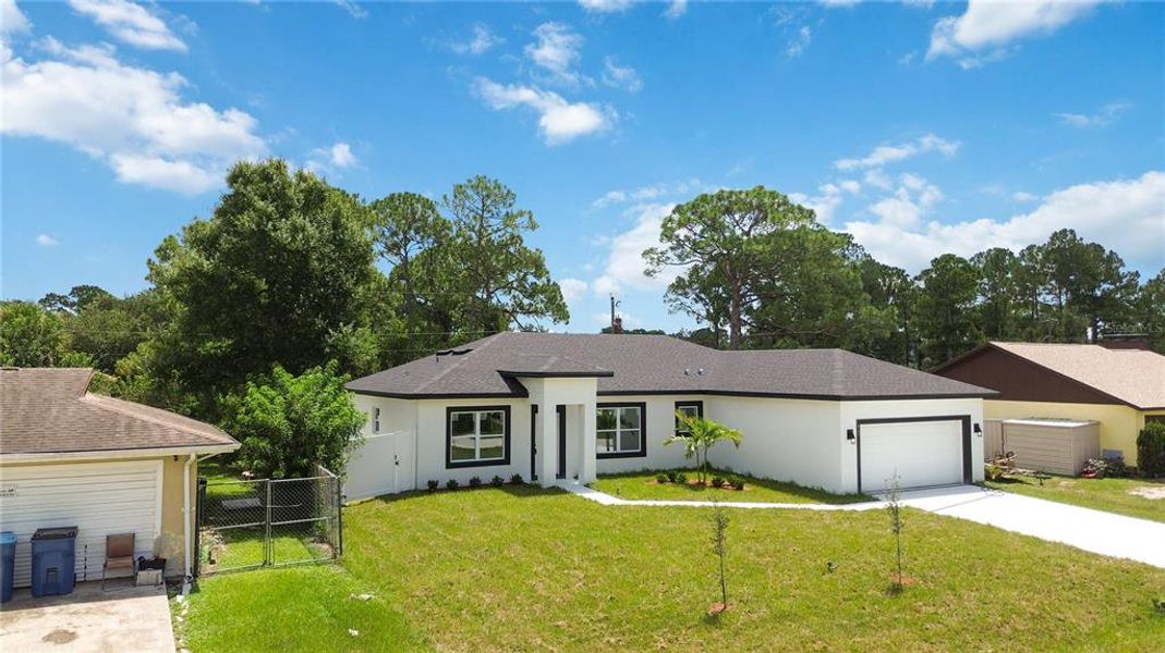 Front exterior of a new home in , Palm Bay, FL, highlighting curb appeal (Image 2). Front exterior of a new home in , Palm Bay, FL, highlighting curb appeal (Image 2).