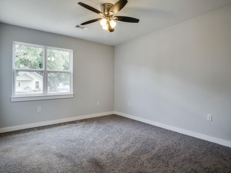 Unfurnished room featuring ceiling fan and carpet floors Unfurnished room featuring ceiling fan and carpet floors