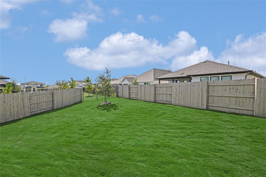 Fenced backyard with a residential view