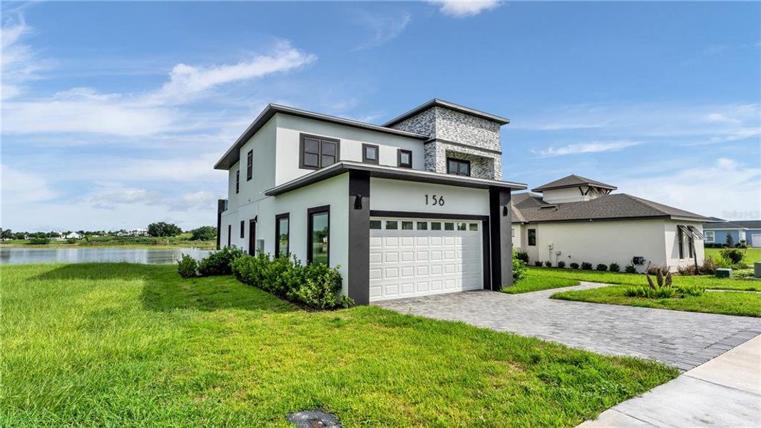 Front exterior of a new home in , Lake Alfred, FL, highlighting curb appeal (Image 26).