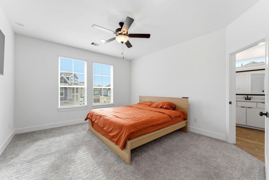 Spacious primary retreat with abundant natural light, high ceilings, and room for a king-size bed.