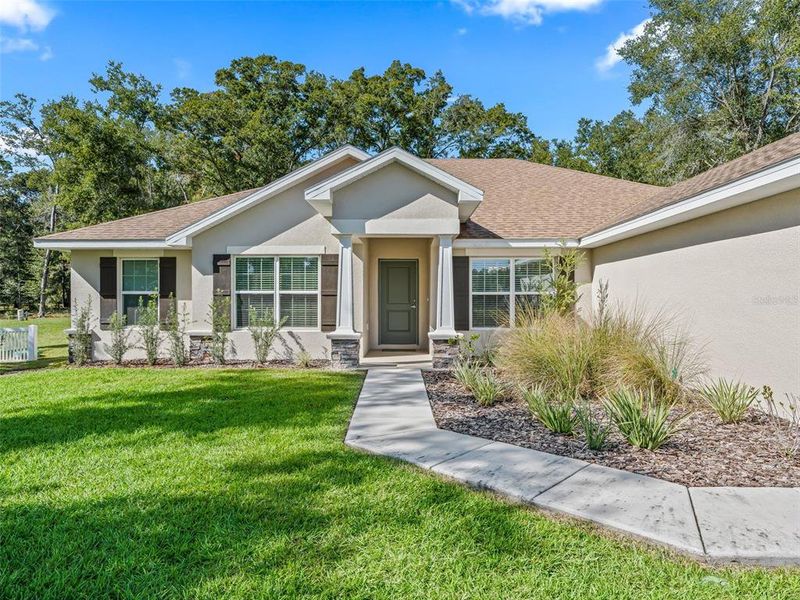 Front exterior of a new home in Dorchester, Ocala, FL, highlighting curb appeal (Image 24).