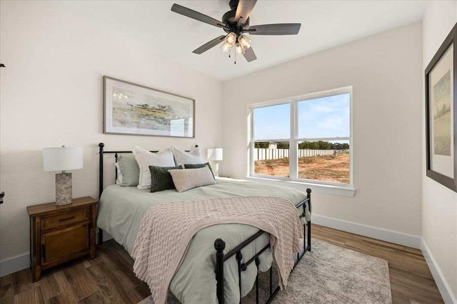 Bedroom featuring wood-finish flooring and a ceiling fan with integrated lighting