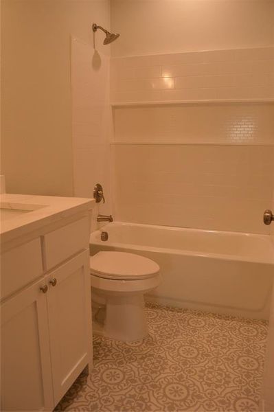 Full bathroom featuring vanity, toilet, and tub / shower combination