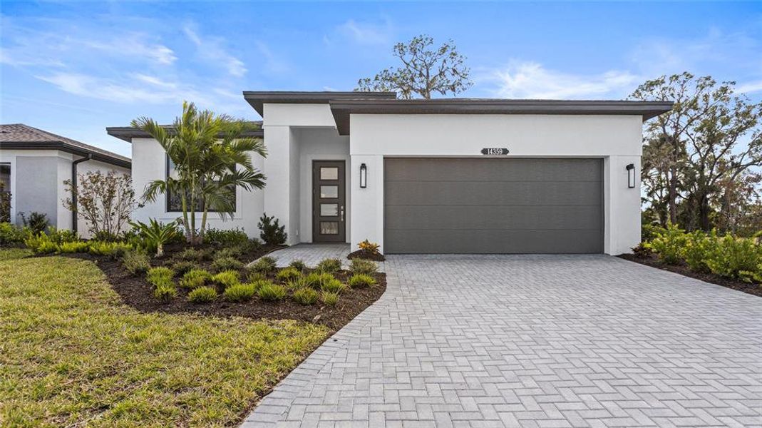 Front exterior of a new home in Woodland Preserve, Parrish, FL, highlighting curb appeal (Image 17).